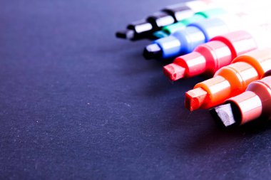 Siyah arka plan üzerinde renkli işaretleyicileri kalem necklac.