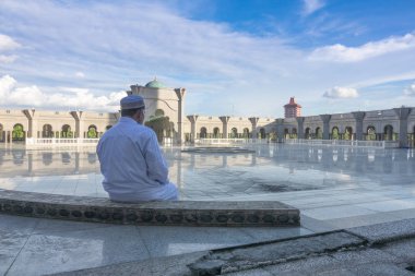 Middle age muslim man praying at mosque. clipart