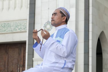 Orta yaş Müslüman erkek camide dua.