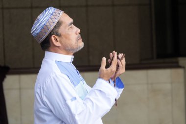 Orta yaş Müslüman erkek camide dua.