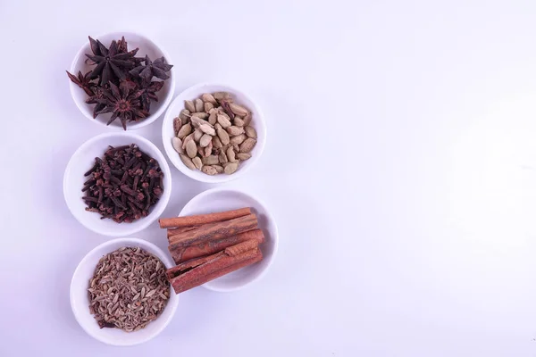 Various indian spices on a white background.