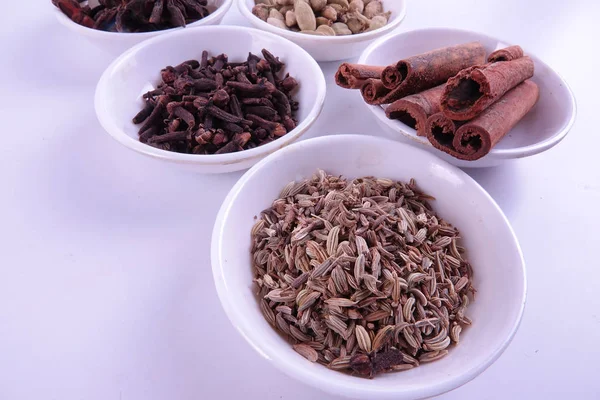 Various indian spices on a white background.