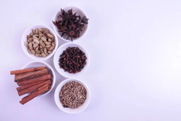 Various indian spices on a white background.