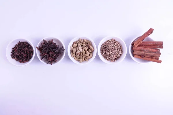 Various indian spices on a white background.