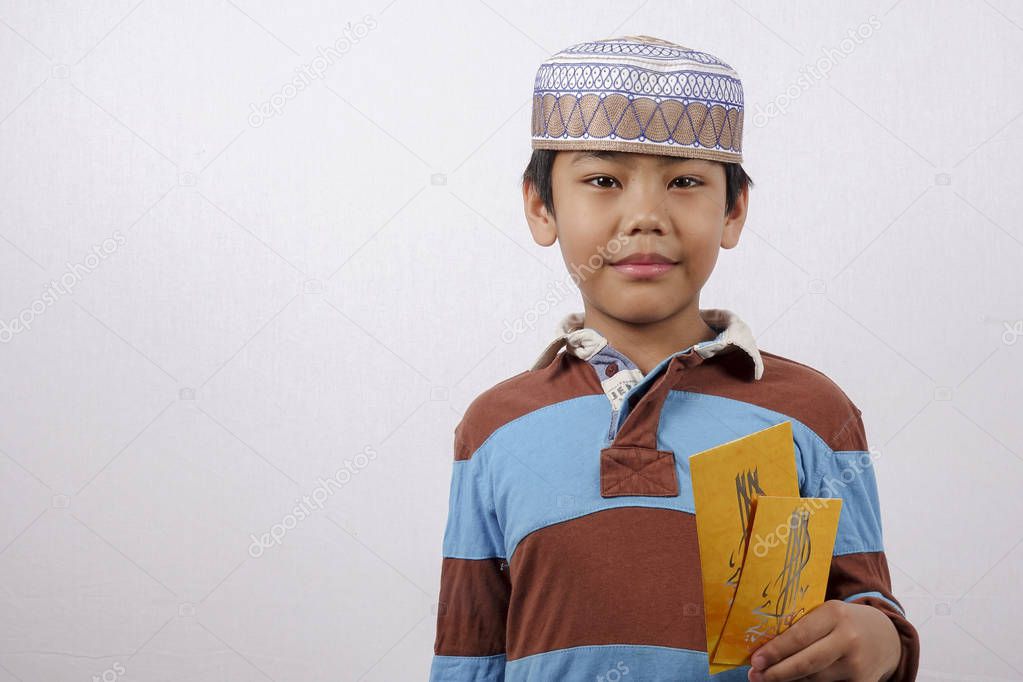 Boy holding money paket for Eid Mubarak.