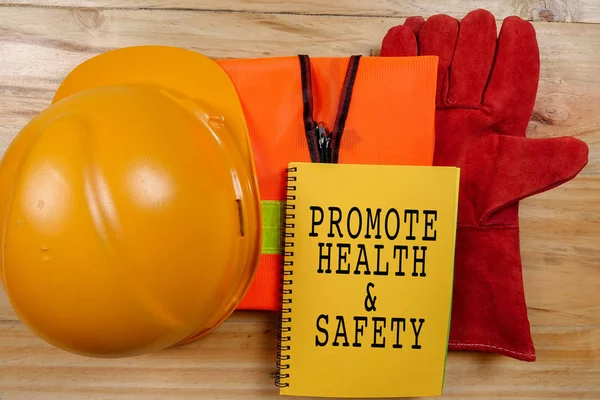 HEALTH,SAFETY & ENVIRONMENT CONCEPTUAL with general texts and standard construction safety equipment