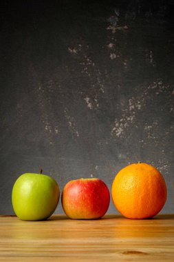 Bir portakal ve elma grunge siyah arka plan üzerinde