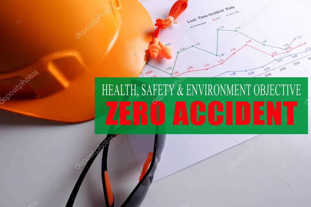 HEALTH,SAFETY & ENVIRONMENT OBJECTIVE: ZERO ACCIDENT with yellow hardhat ,safety glass and ear plug over accident statistic graph.