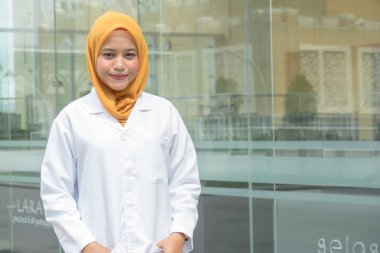 Kendine güvenen kadın doktor ofisi infront ayakta ve kamera, sağlık ve önleme kavramı gülümseyen