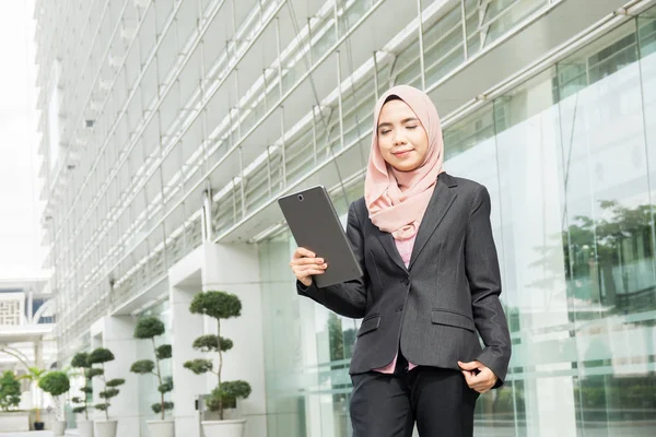 Young muslim woman use smart phone at outside office area.