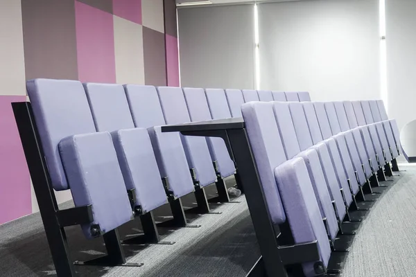 Lecture hall with grey chairs in university