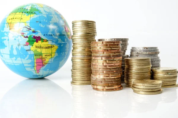Weltwirtschaftskonzept Mit Kugel Und Gestapelten Münzen Über Weißem Grund — Stockfoto
