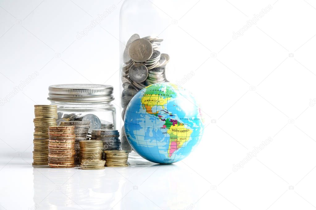 Global economy concept with sphere globe and stacked of coins over white.