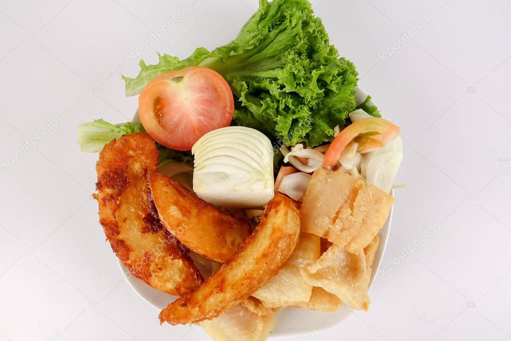 Fish and Chips with vegatables isolated on white.