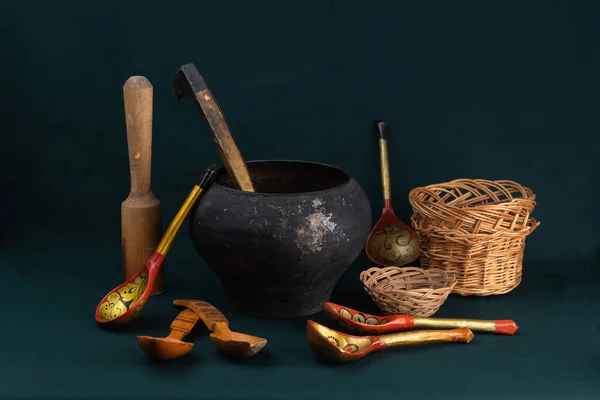 Composition of old, rare dishes. Old household items. Original utensils. culture of Russia. Objects on a dark background.