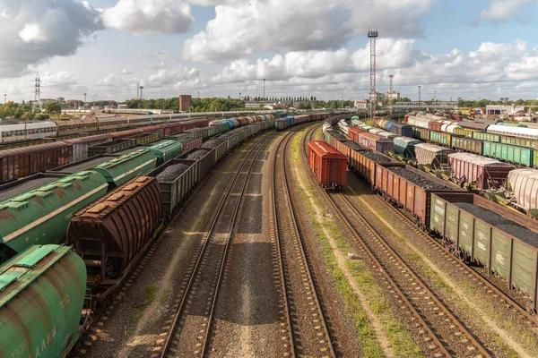 Tanks and freight cars at the sorting railway junction. Long railway trains for transportation of various goods. Railway transport logistics