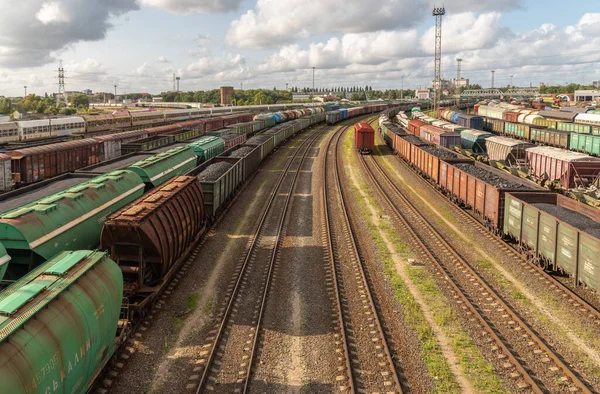 Tanks and freight cars at the sorting railway junction. Long railway trains for transportation of various goods. Railway transport logistics
