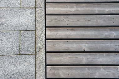 Gri ahşap döşeme ve granit döşeme parçaları. Farklı malzemelerin dokusu, bitiş taşı ve tahtalar bir arada..