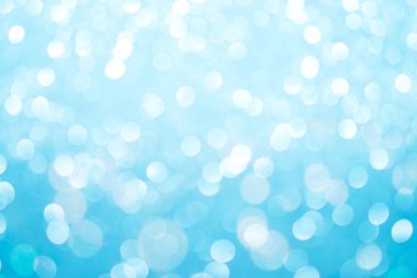 Bokeh 'in odağını kaybetmiş ışıklarla güzel mavi soyut bir arka plan. Kış ve yeni yıl arkaplanı..