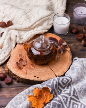 Sonbahar yaprakları ve ahşap masa üzerinde çay