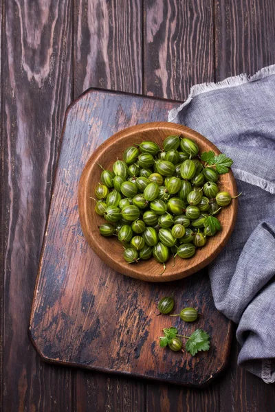 Sweet fresh gooseberry berry in a bowl on dark background. top view — Stock Photo, Image