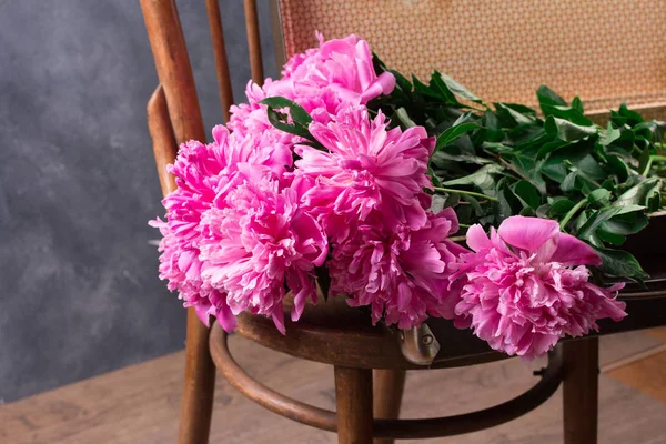 Schöne rosa Pfingstrosenblüten auf grauem Tisch — Stockfoto