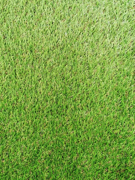 Falešný zelený trávník pole koberec pro sportovní pozadí. — Stock fotografie