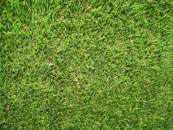 Fake Green gras veld tapijt voor sport achtergrond. — Stockfoto