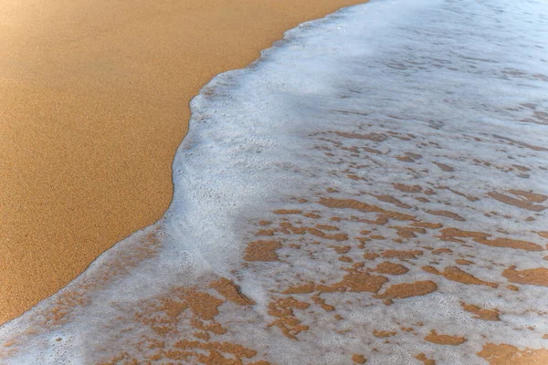 Sea foam on the beautiful sand Atlantic ocean beach in France.