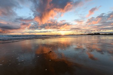 Atlantik Okyanusu 'nda güneş batıyor. Fransa' da turuncu plaj ve gökyüzü var..