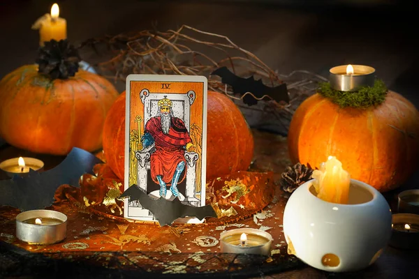 ritual with tarot cards, and candles. Halloween concept, black magic or fortune telling rite with occult and esoteric symbols. . High quality photo