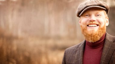 Dışarıda gülümseyen sakallı yakışıklı bir adam portresi. Yüksek kalite fotoğraf