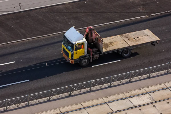 Truck with a loading dock on city streets. Truck cranes manipulator. Truck crane boom and empty space