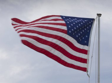Hızlı bulutların arkasına rüzgarla sallayarak Amerika Birleşik Devletleri bayrağı