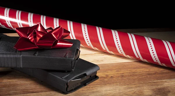 Polymer gun magazines with red Christmas ribbon and wrapping paper