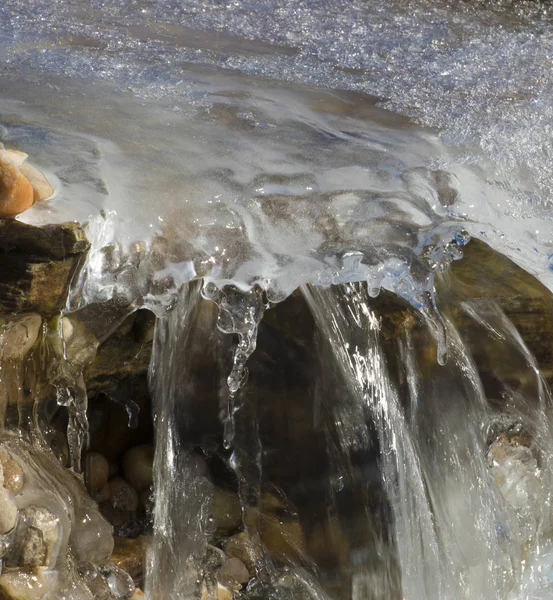 stock image Waterfall flowing under the ice