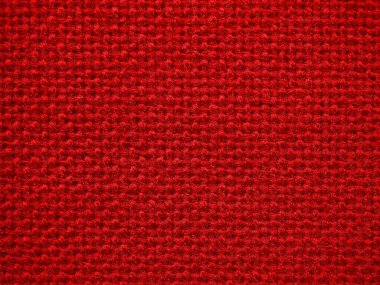 Kırmızı tekstil dokusunun, arka planının ve duvar kağıdının yakın çekimi. Mobilya döşemesinin kırmızı kumaş dokusu. Yüksek kaliteli makro fotoğrafçılık.