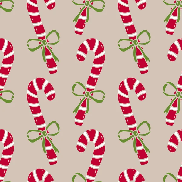 Jul sömlösa mönster av godis käppar. Ljust omslagspapper på beige bakgrund. — Stock vektor