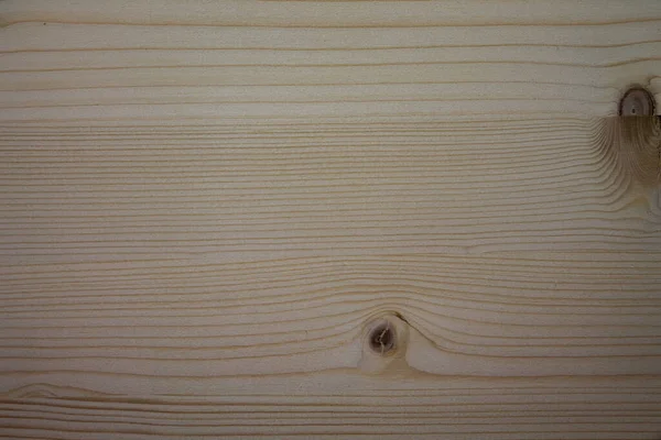 A spruce wood texture with vertical knots.