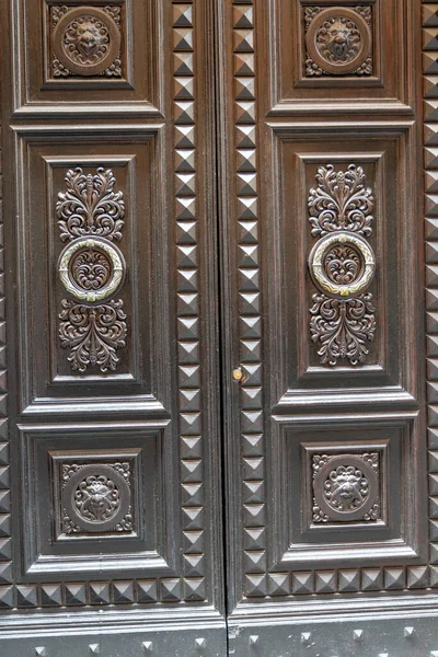 armored door with wooden cover with two doors