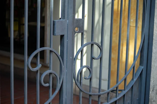 detail of a wrought iron gate for shop placed outside