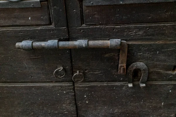 vintage latch on a historic door with signs of rust