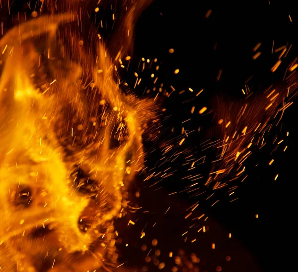 Siyah arkaplanda kıvılcımlar saçan ateş alevleri