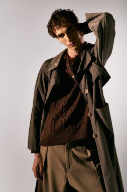 A handsome young man poses confidently in trendy attire, highlighting his unique style and charisma.