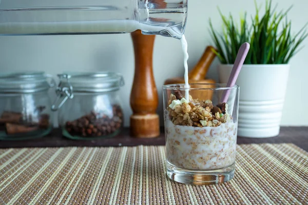 Useful muesli with milk in a glass on a wooden table. Healthy lifestyle — Stock Photo, Image