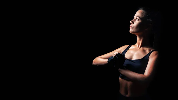 Sexy athletic fitness woman. Black background