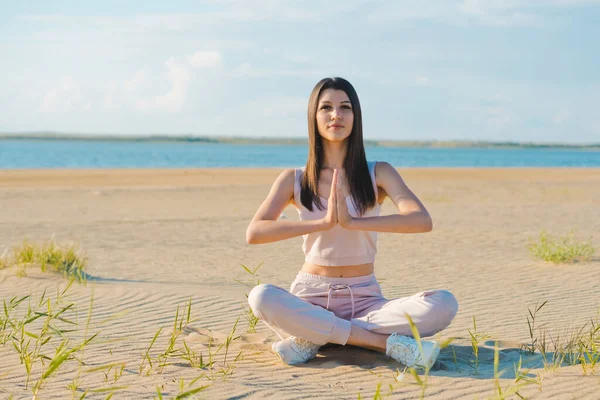 Trevlig Kvinna Ros Träningsoverall Gör Yoga Stranden — Stockfoto