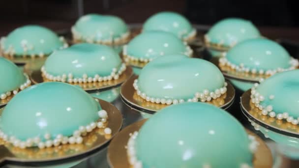 Eventos festivos cupcakes turquesa e biscoitos em uma bandeja espelhada. Câmera em movimento — Vídeo de Stock