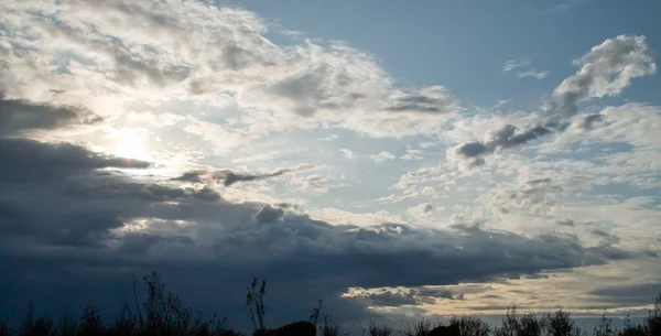 Landscape of a sky with clouds at sunset. Last rays of sun before sunset in the countryside.