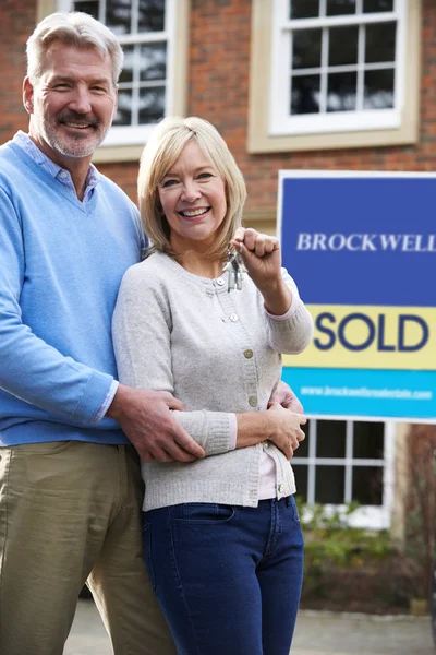 Portrait Of Mature Couple With Keys To New Home